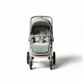 Baby stroller with adjustable seat and safety harness in green fabric